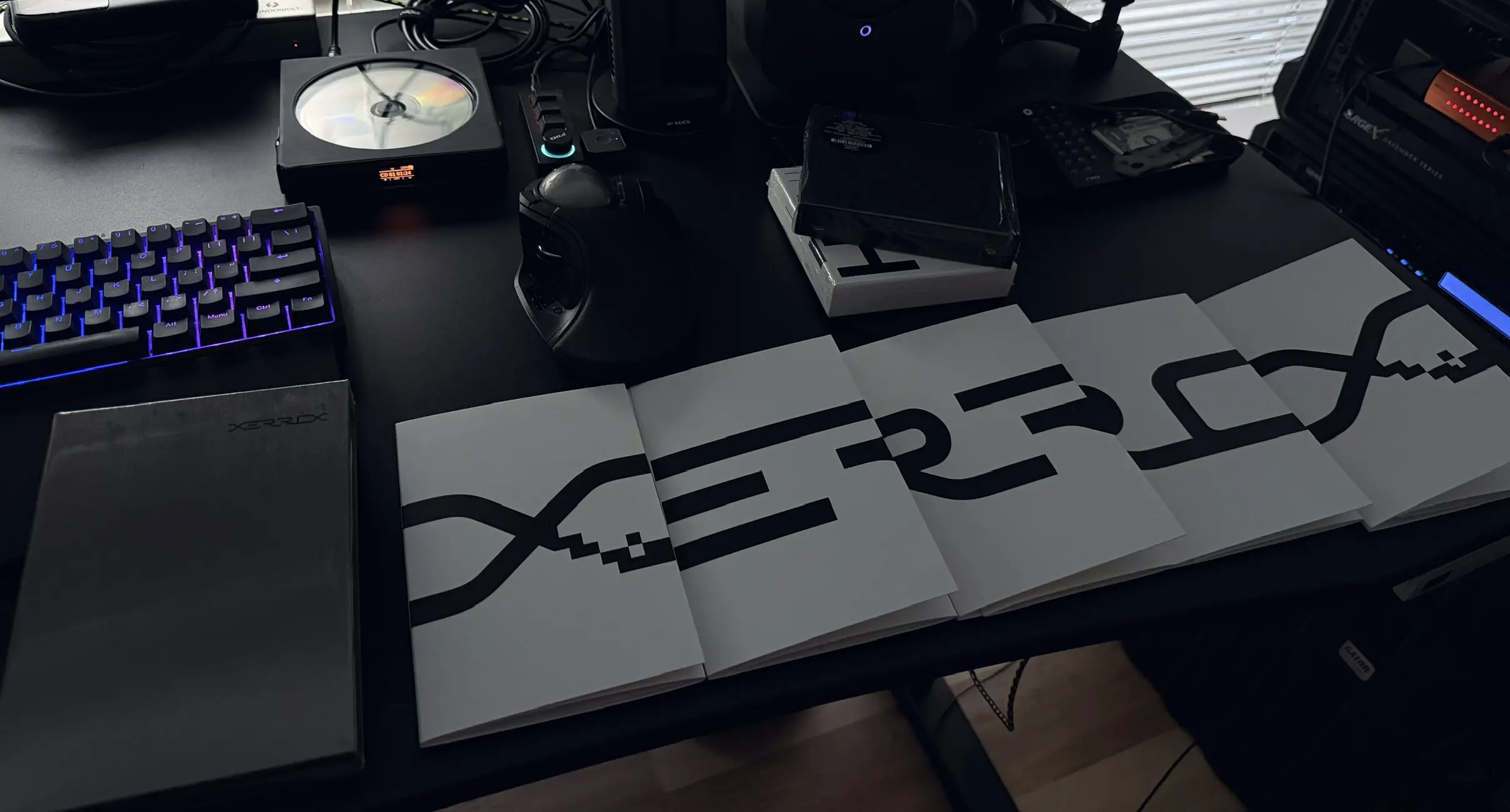 The Alva Noto Xerrox box set spread open on a desk, blue-lit mechanical keyboard to the left